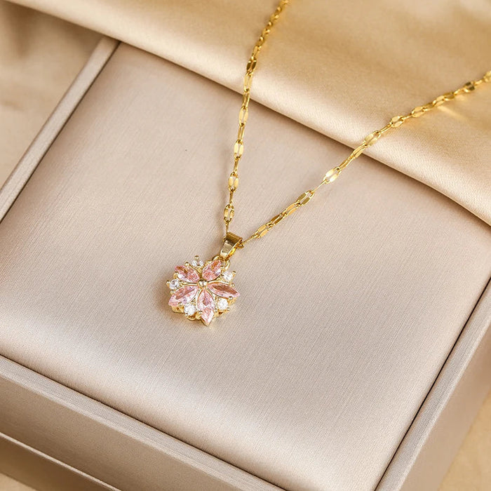Elegant gold necklace with a delicate pink flower pendant